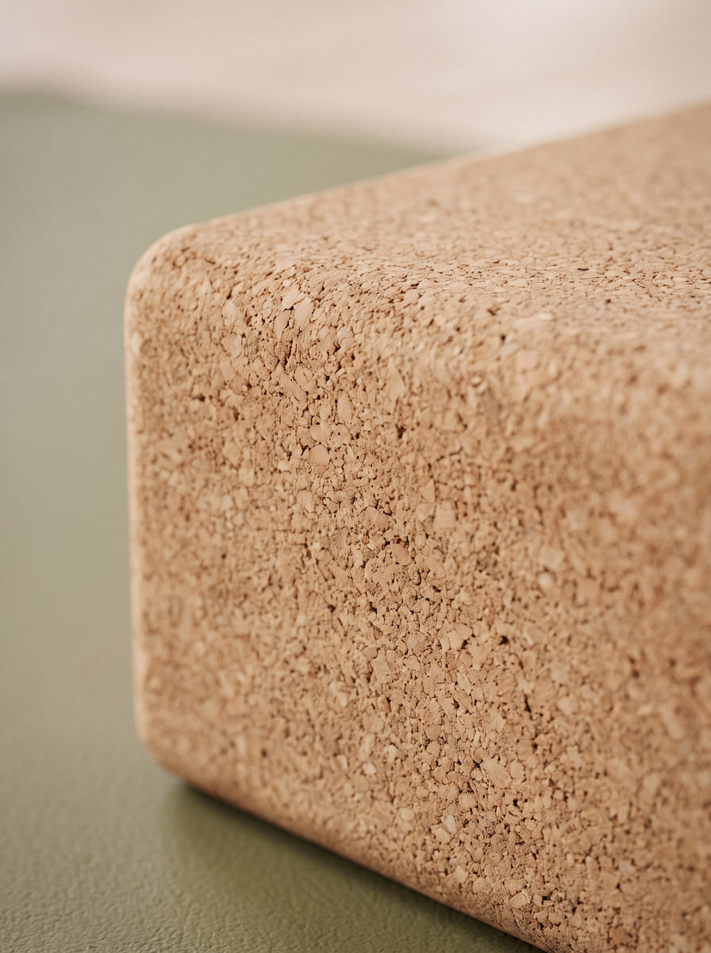 Close-up of the fine cork texture and rounded edge of a yoga block