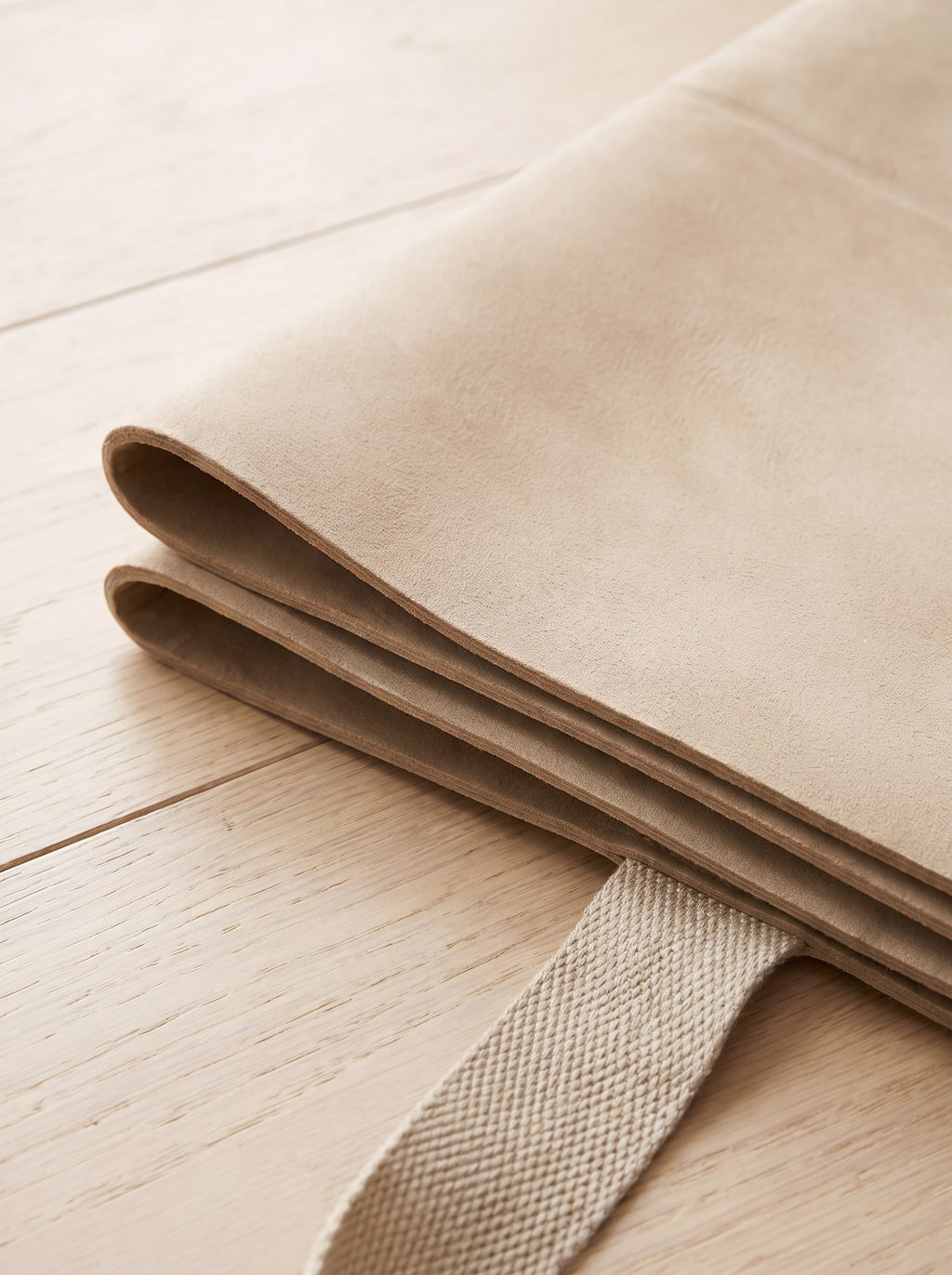 Close-up of the suede-feel surface and folded edge of the travel yoga mat