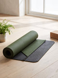 Olive Natural Rubber Yoga Mat 4 mm half unrolled on an oak studio floor